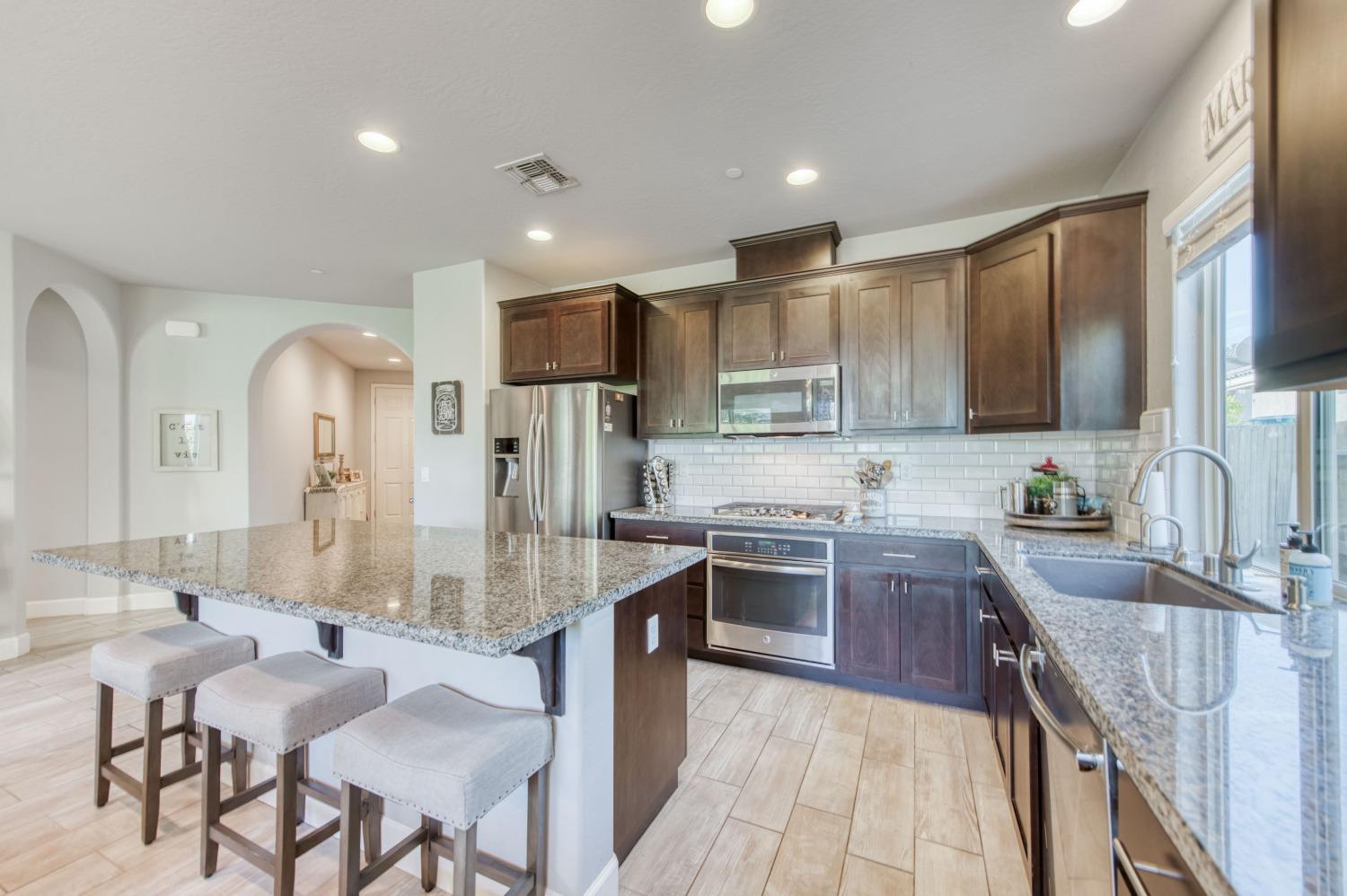 3539 Taylor Lane Clovis, CA 93619 - Photo 9 of 33 a large kitchen with granite countertop lots of counter space a sink and appliances
