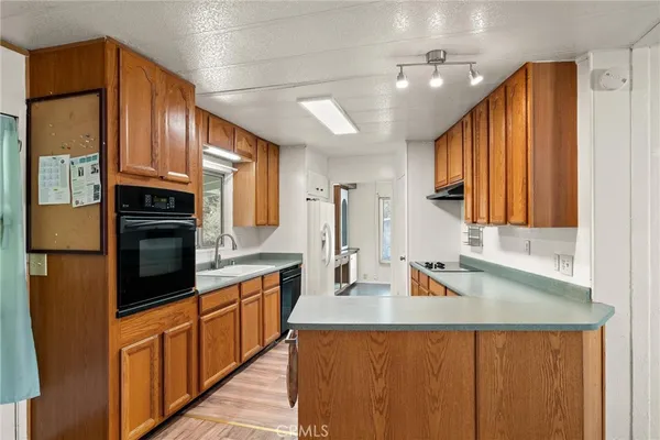 a kitchen with stainless steel appliances a sink stove and cabinets