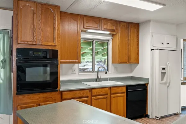 a kitchen with stainless steel appliances granite countertop a refrigerator and a sink