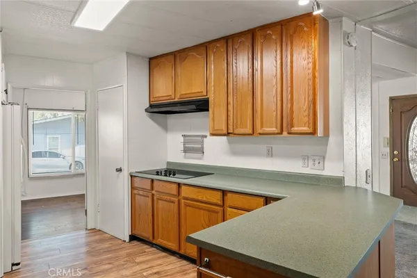 a kitchen with stainless steel appliances granite countertop wooden cabinets a sink and dishwasher