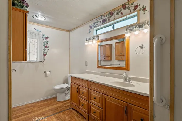 a bathroom with a window and a toilet