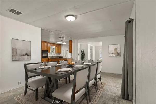 a view of a dining room with furniture and window