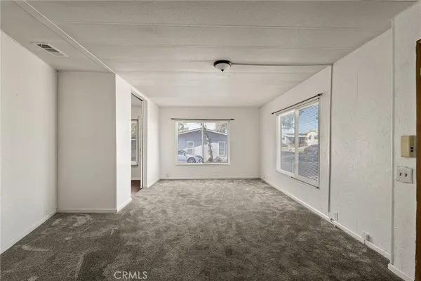 a big room with closet and windows