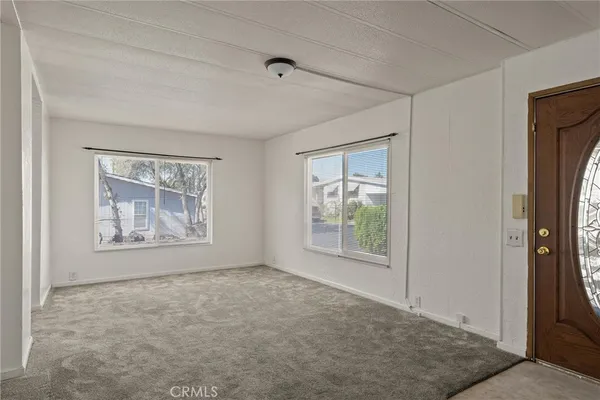 an empty room with windows and closet