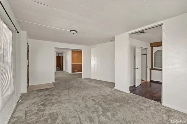 a view of a big room with closet and windows