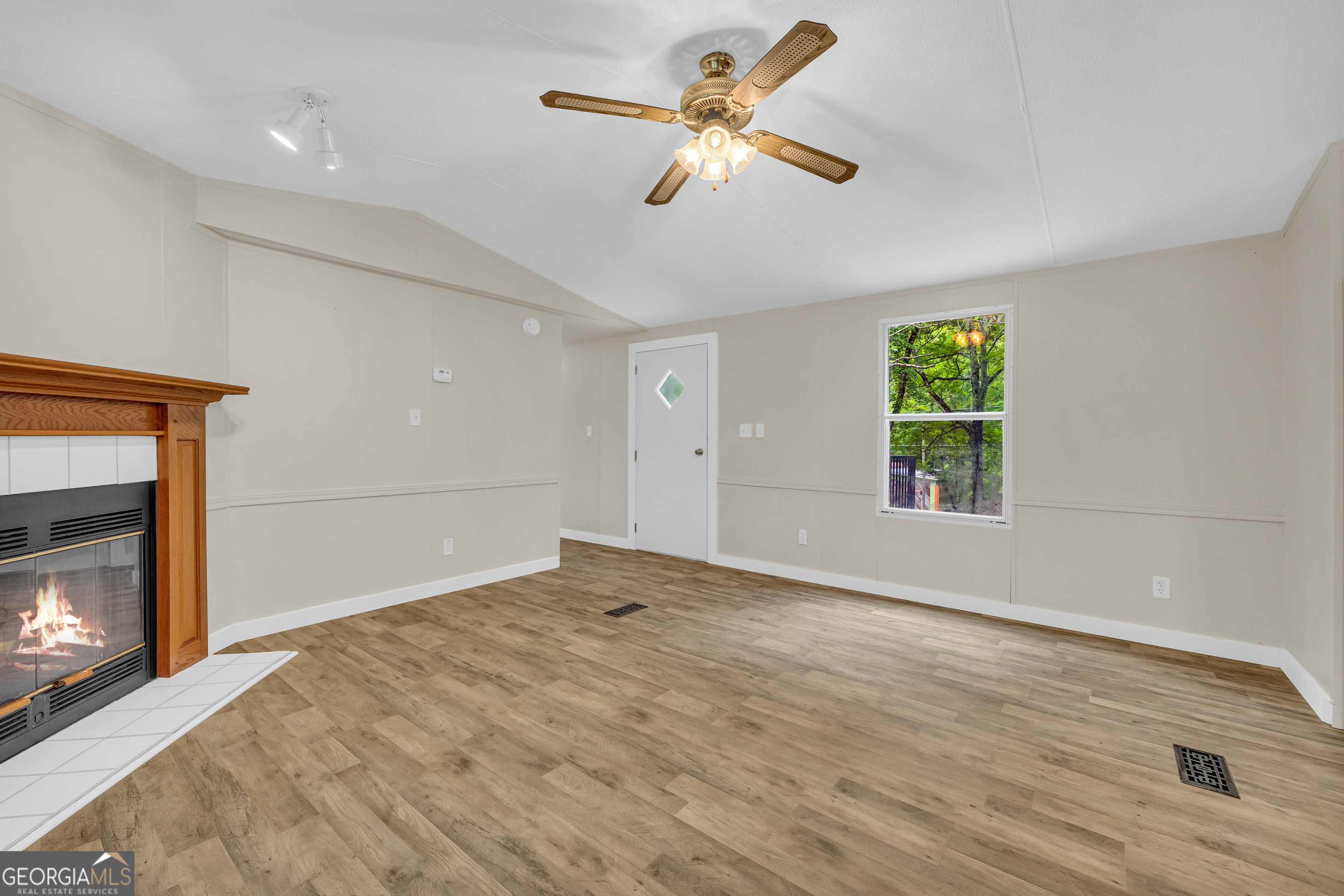 162 Stillwater Road Lavonia, GA 30553 - Photo 11 of 45 a view of empty room with window and fireplace