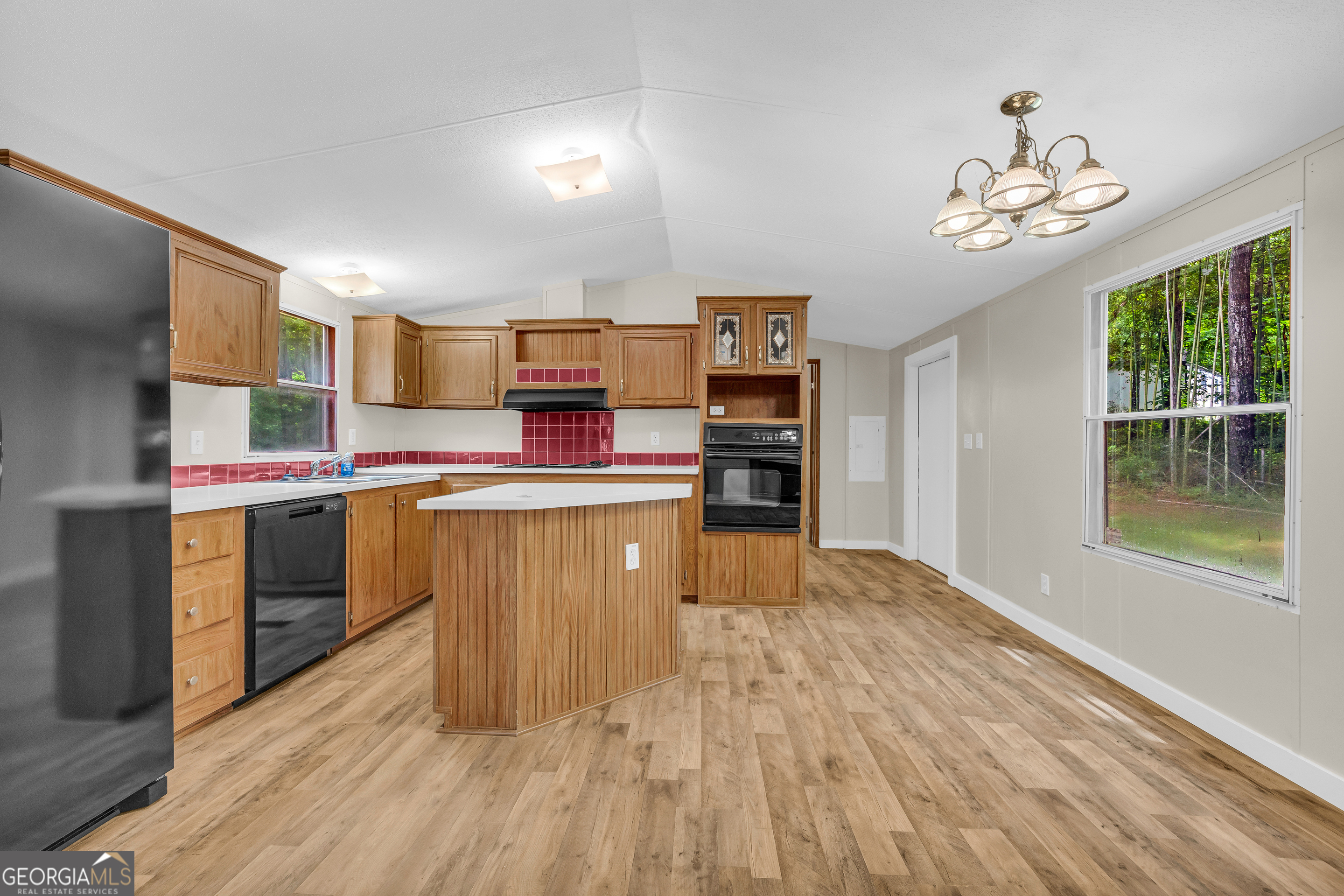 162 Stillwater Road Lavonia, GA 30553 - Photo 18 of 45 a kitchen with kitchen island granite countertop a stove top oven sink and cabinets