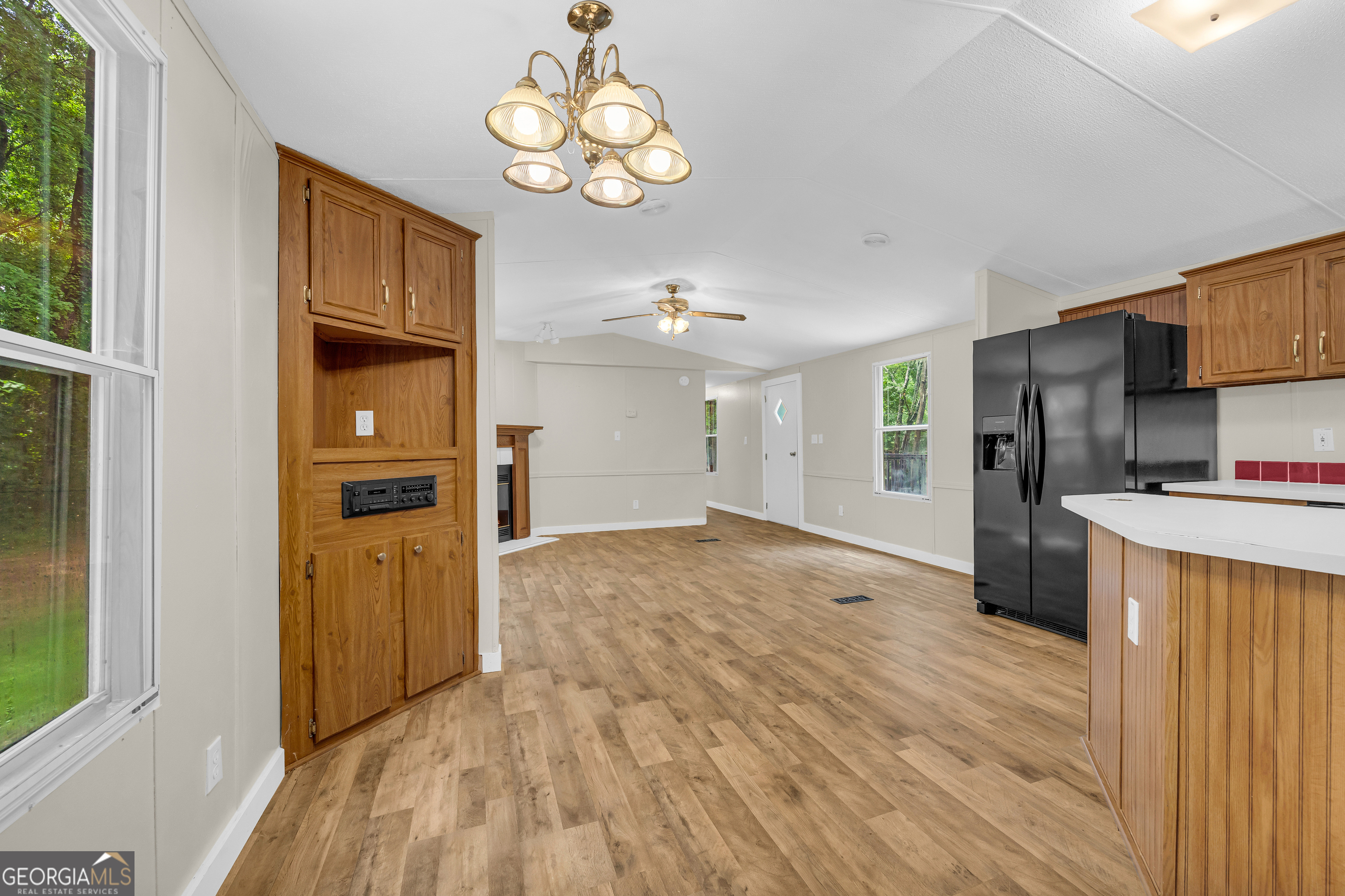 162 Stillwater Road Lavonia, GA 30553 - Photo 20 of 45 a view of a kitchen with wooden floor and a refrigerator