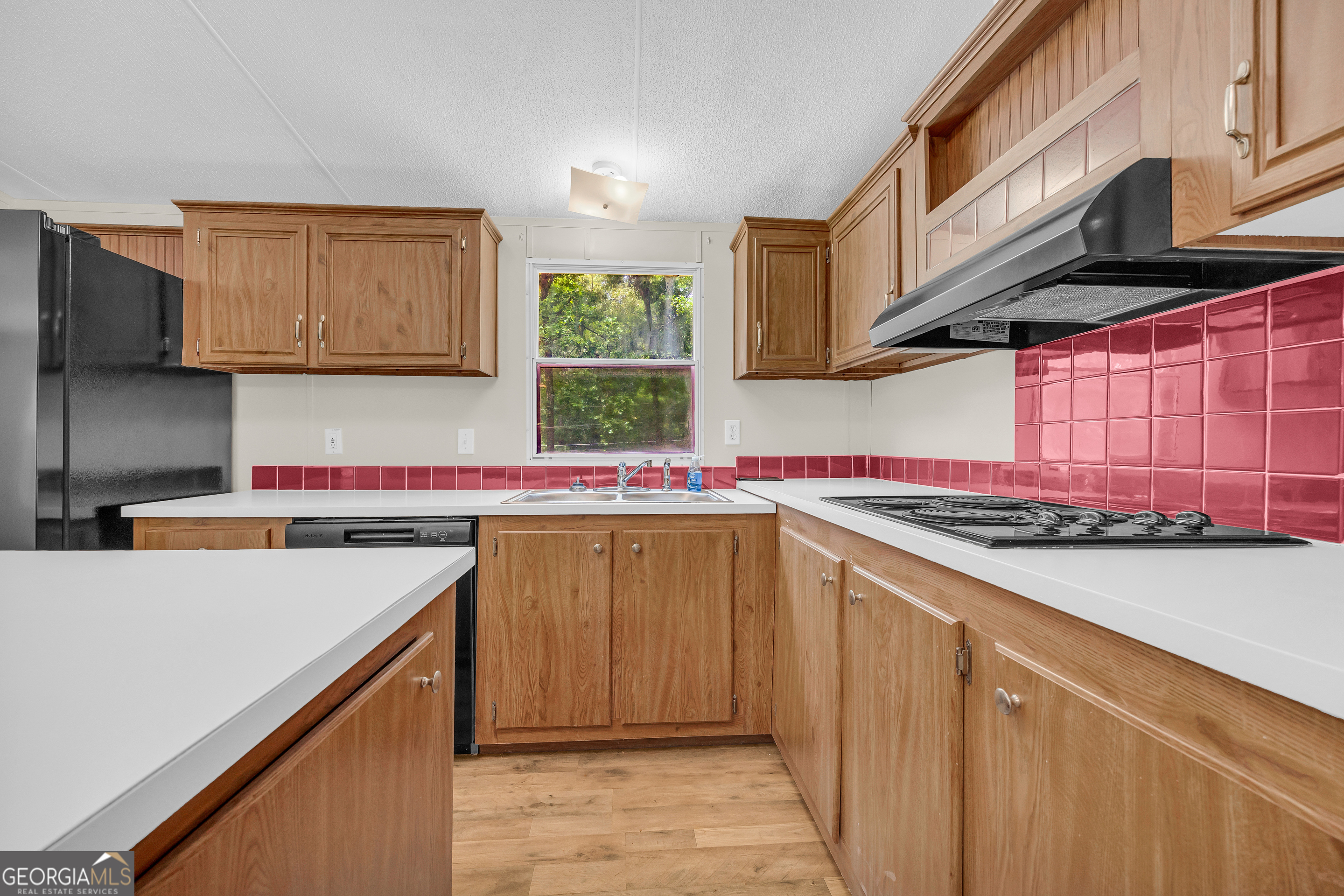 162 Stillwater Road Lavonia, GA 30553 - Photo 23 of 45 a kitchen with stainless steel appliances a sink a stove and a refrigerator