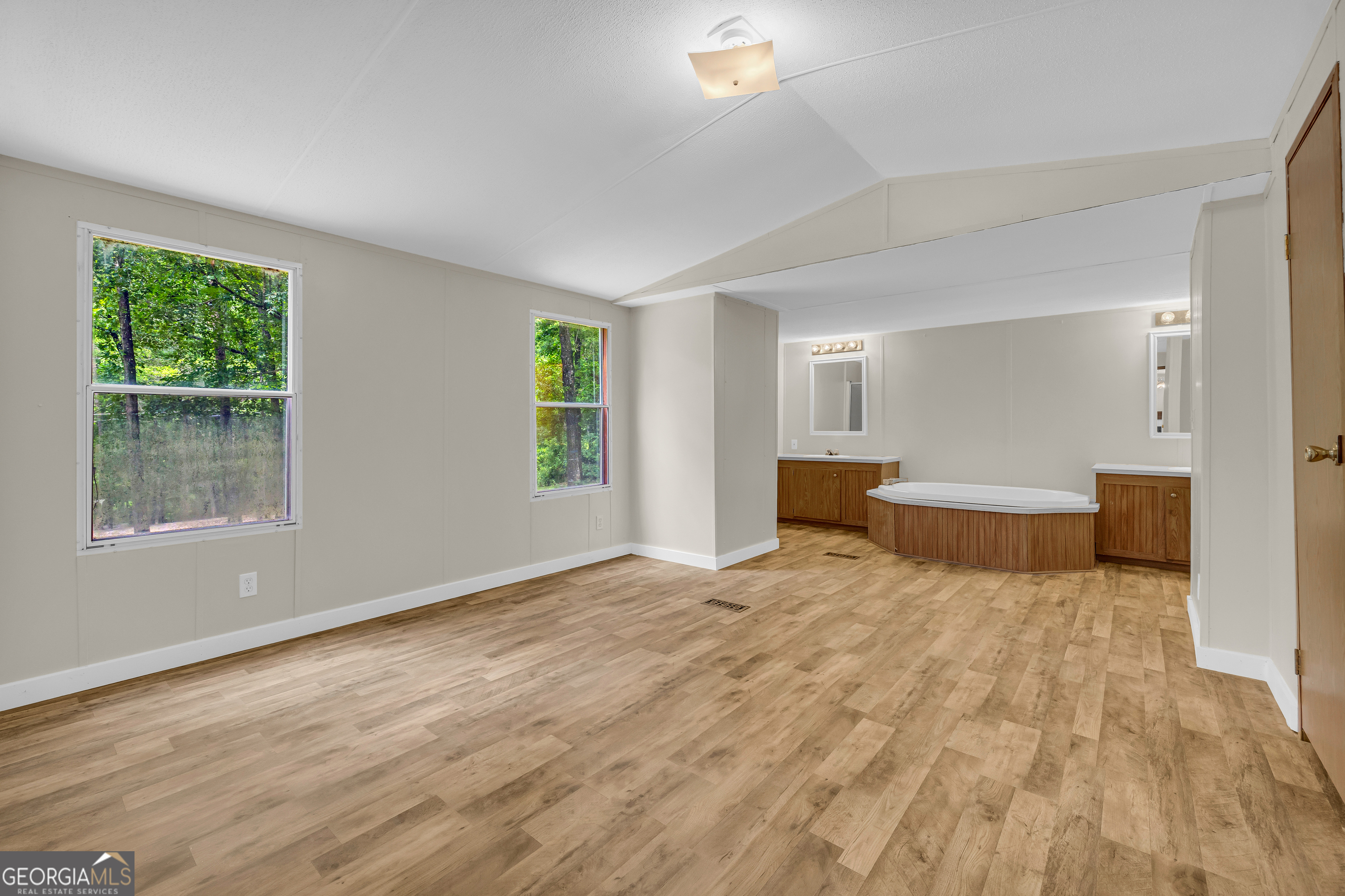 162 Stillwater Road Lavonia, GA 30553 - Photo 27 of 45 a bedroom with a bed and a large window