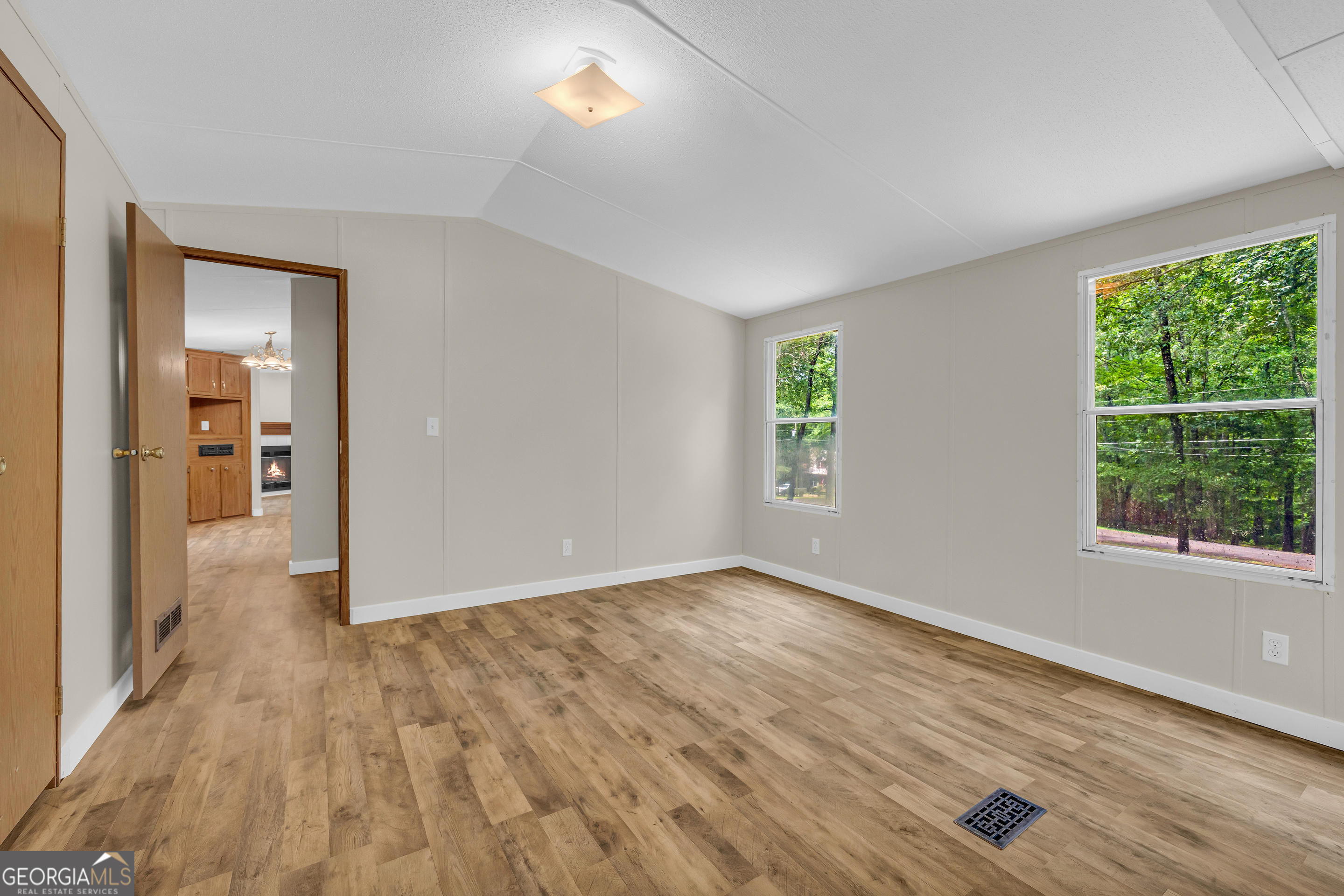 162 Stillwater Road Lavonia, GA 30553 - Photo 28 of 45 an empty room with wooden floor and windows