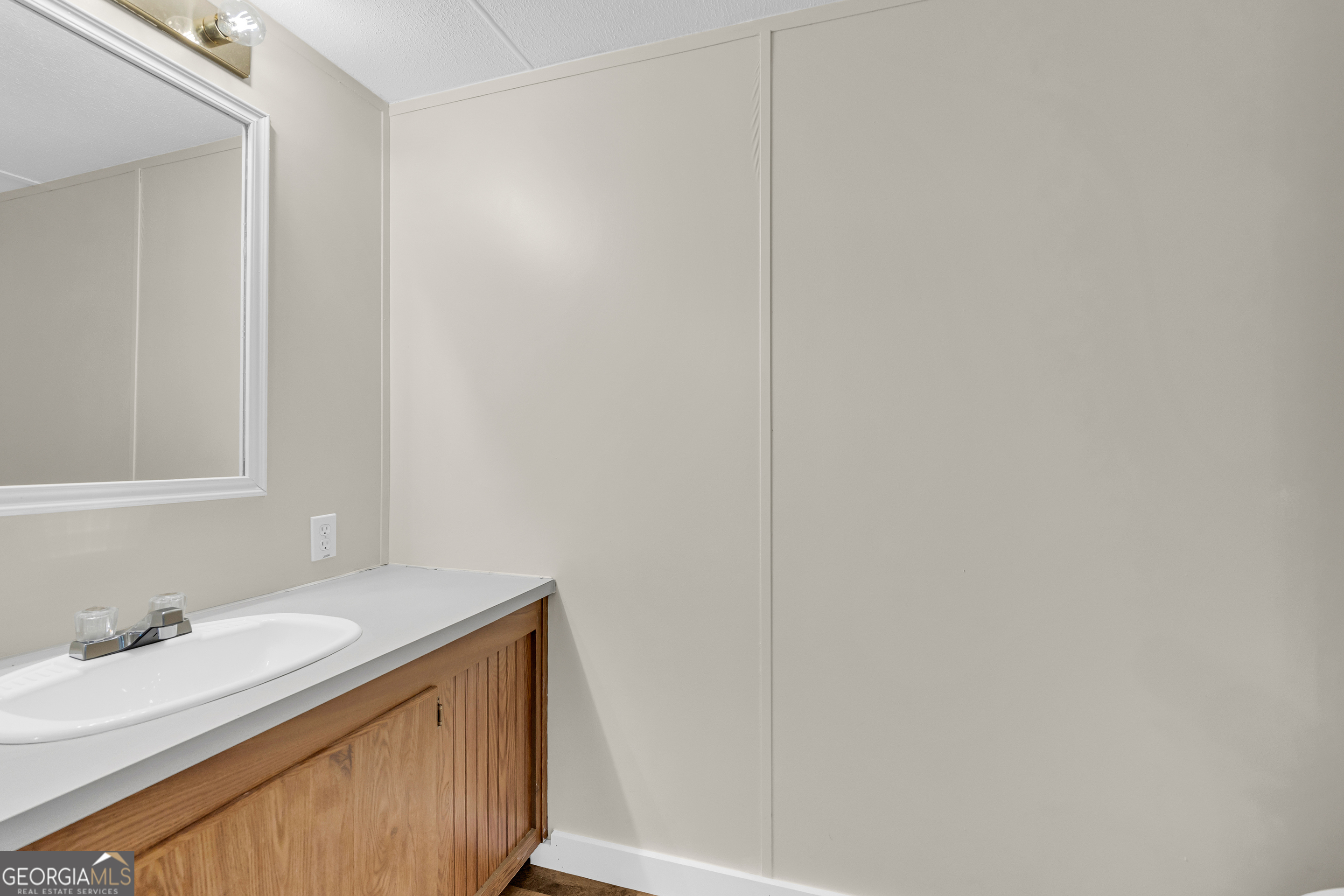 162 Stillwater Road Lavonia, GA 30553 - Photo 32 of 45 a bathroom with a granite countertop sink and a mirror