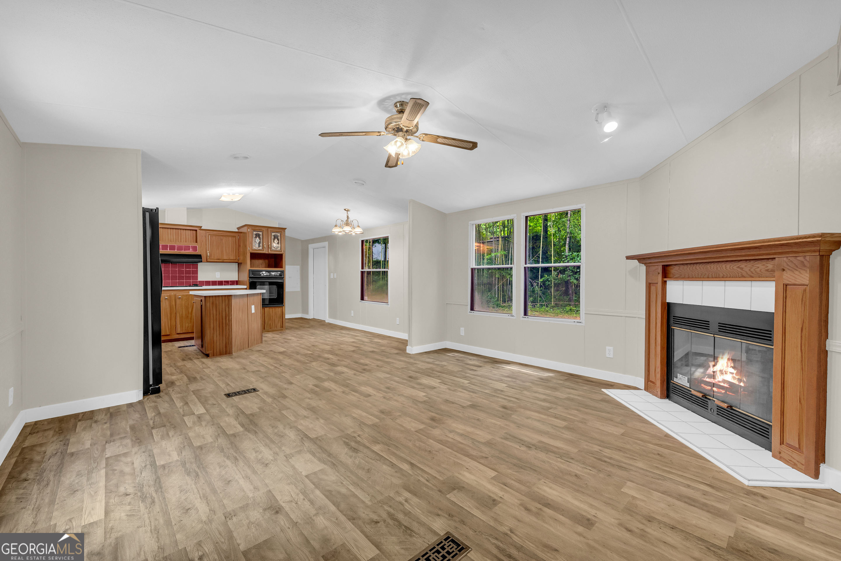 162 Stillwater Road Lavonia, GA 30553 - Photo 9 of 45 a view of an empty room with a window and fireplace