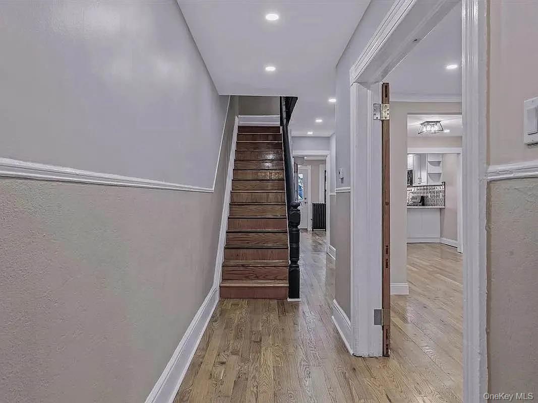 643 Decatur Street, Unit 1 Brooklyn, NY 11233 - Photo 11 of 27 a view of a hallway with wooden floor and staircase
