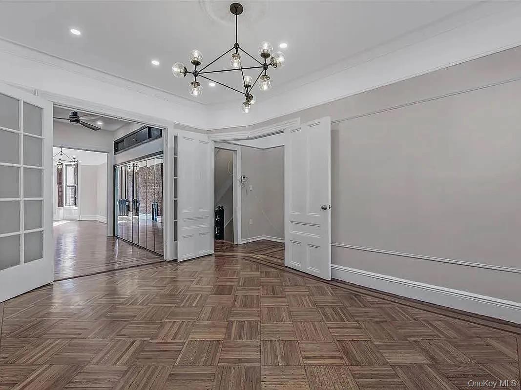 643 Decatur Street, Unit 1 Brooklyn, NY 11233 - Photo 15 of 27 a view of a livingroom with wooden floor and a ceiling fan