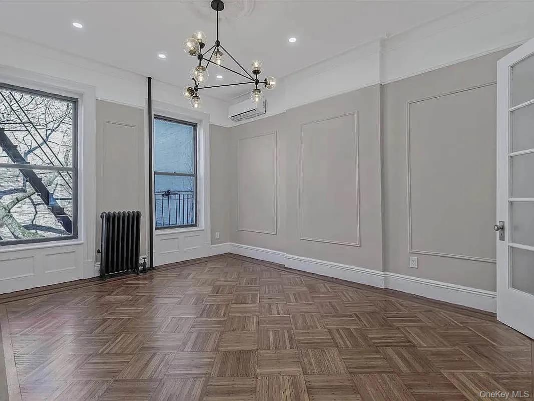 643 Decatur Street, Unit 1 Brooklyn, NY 11233 - Photo 16 of 27 a view of a livingroom with a chandelier