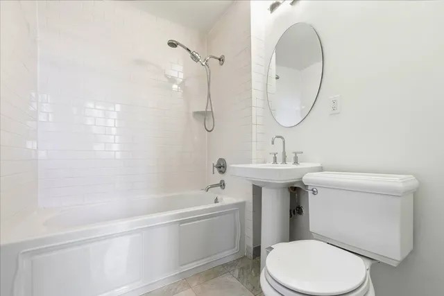 a bathroom with a sink a toilet and a mirror