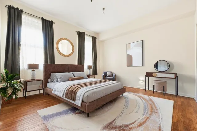 a bedroom with a bed and chair