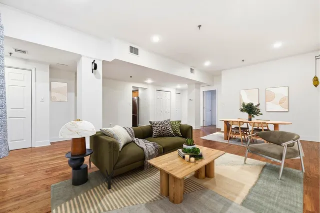 a living room with furniture and wooden floor