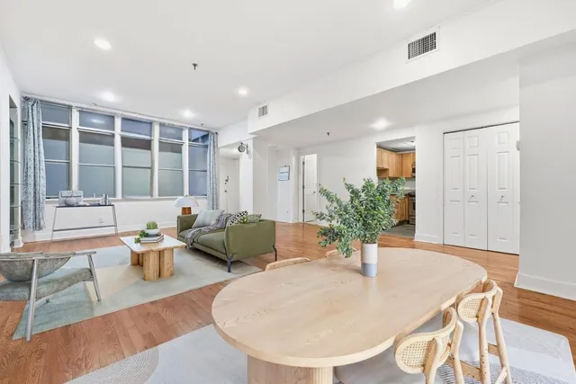 a living room with furniture and large windows