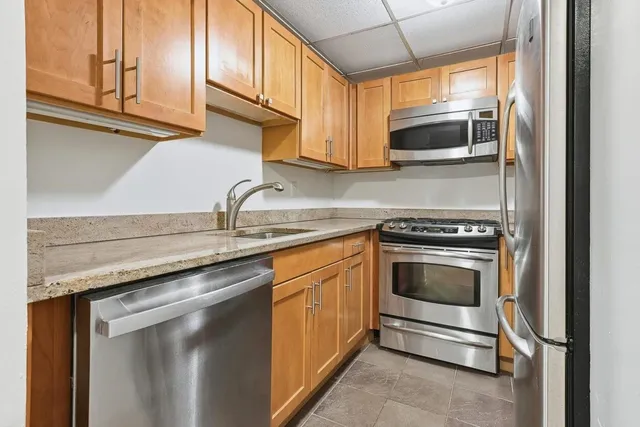 a kitchen with stainless steel appliances granite countertop a sink and a microwave