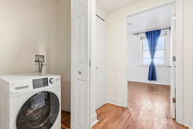 a view of a hallway with washer and dryer