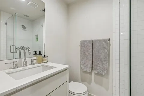 a bathroom with a sink toilet and shower