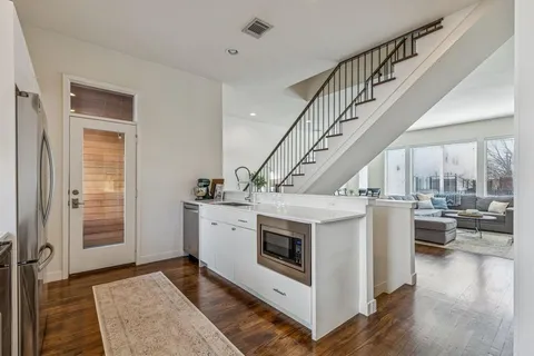 a kitchen with granite countertop a sink stove and refrigerator