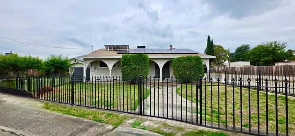 a view of a wrought iron fences in front of house