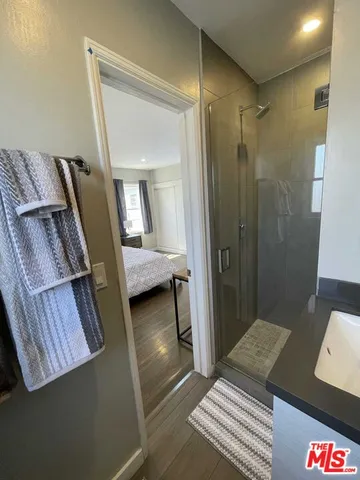 a bedroom with a bed and a mirror