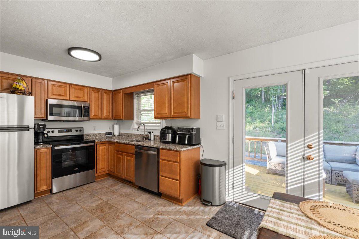 247 Arrowood Road Linden, VA 22642 - Photo 4 of 23 a kitchen with stainless steel appliances granite countertop a stove top oven a sink dishwasher and a refrigerator