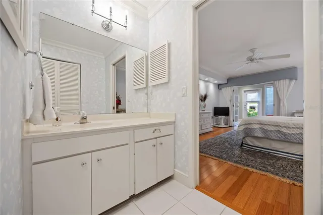 a spacious bathroom with a granite countertop sink a mirror and a bathtub