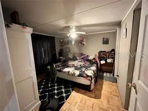 a bedroom with bed and a mirror