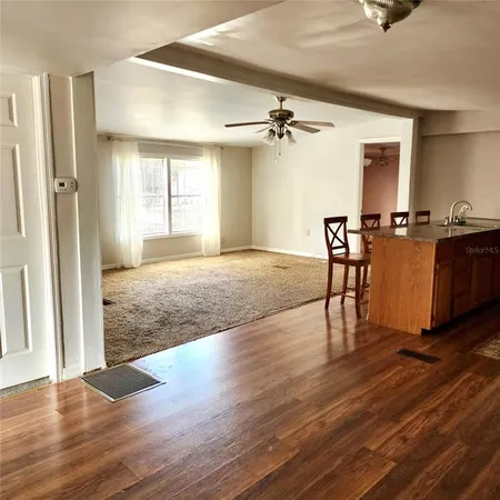 a kitchen with a refrigerator sink and white cabinets