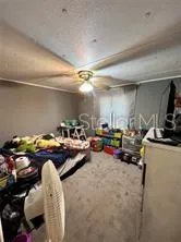 a bedroom with a bed next to a window