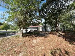 a view of a yard with a tree