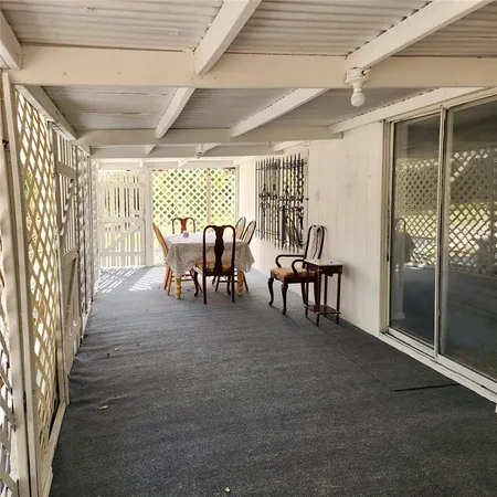 a view of balcony with wooden floor