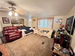 a bedroom with a bed a couch and dresser