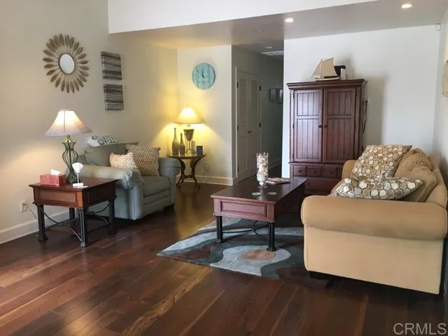 a living room with furniture rug and lamp