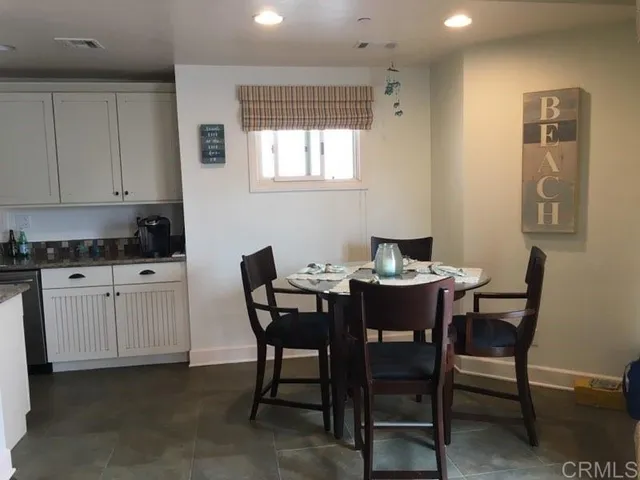 a view of a dining room with furniture and window