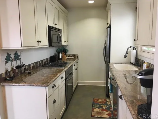 a kitchen with a sink stove and cabinets