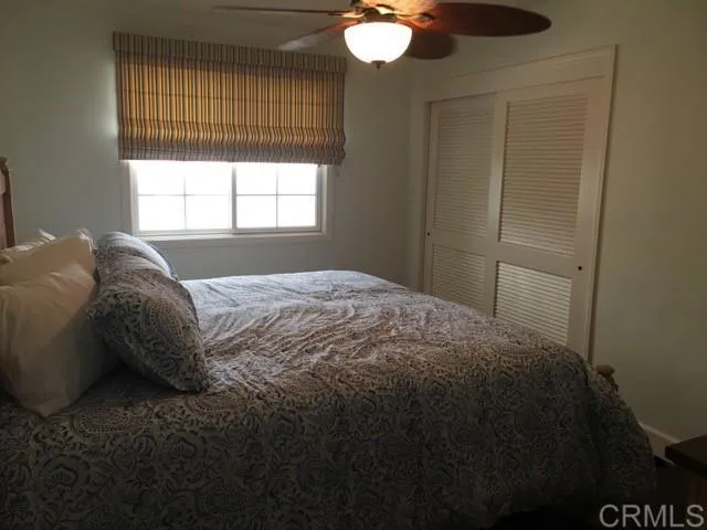 a bed sitting in a bedroom next to a window