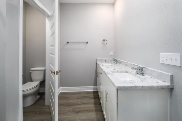 a bathroom with a granite countertop sink toilet and shower