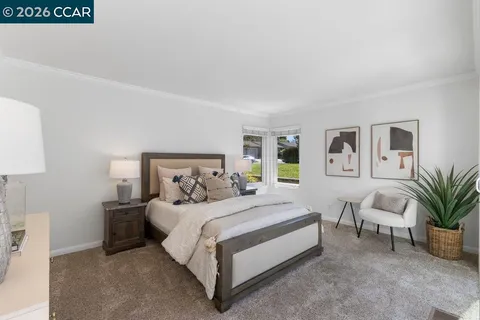 a bedroom with a bed and a couch