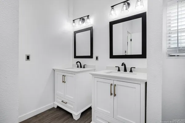 a bathroom with 2 sink and a mirror