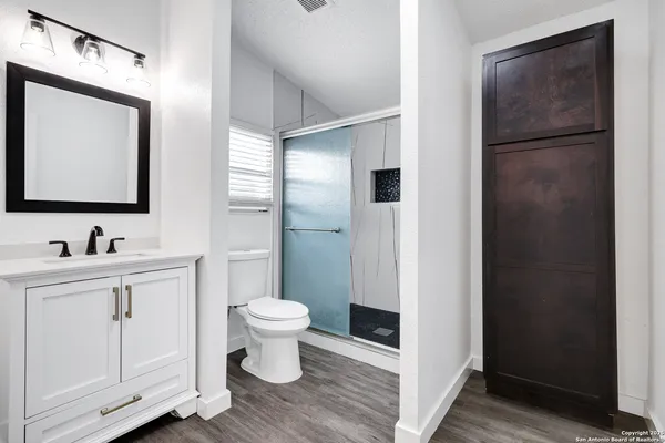 a bathroom with a toilet sink and mirror
