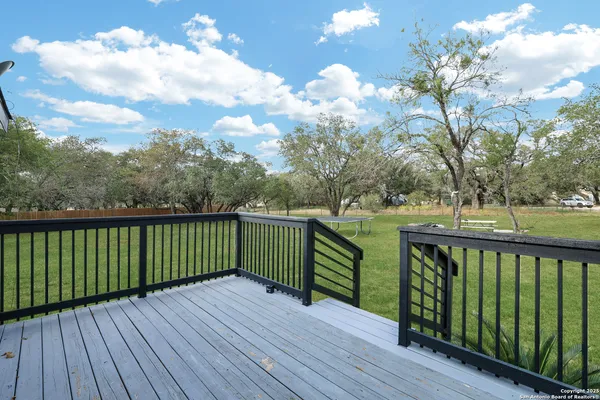 a view of a balcony with wooden fence