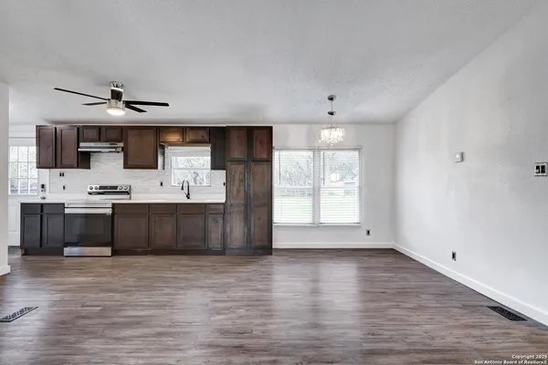 a view of kitchen with cabinets and wooden floor