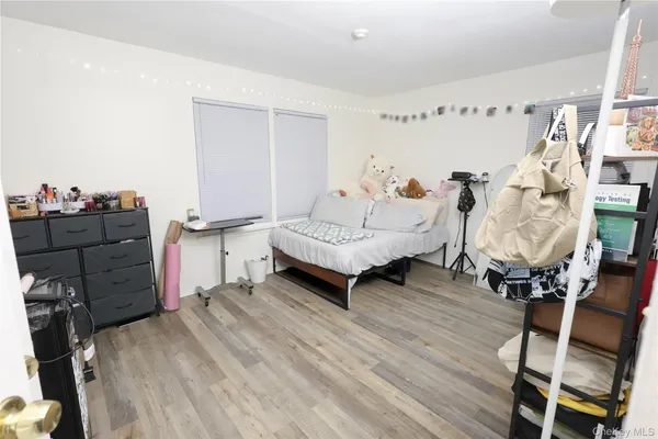 a bedroom with furniture and wooden floor