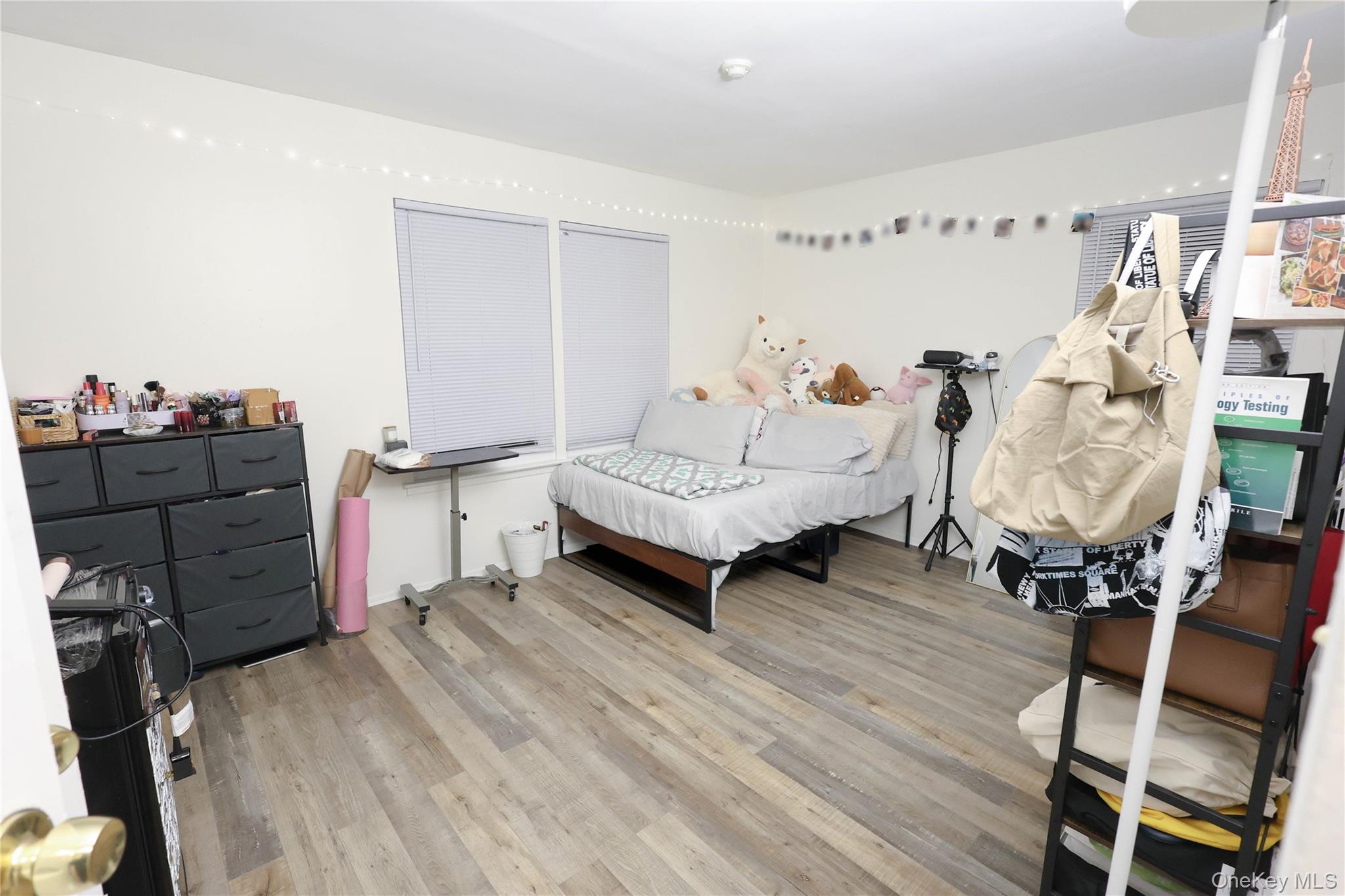 3 Saratoga Court, Unit B Ridge, NY 11961 - Photo 12 of 15 a bedroom with furniture and wooden floor